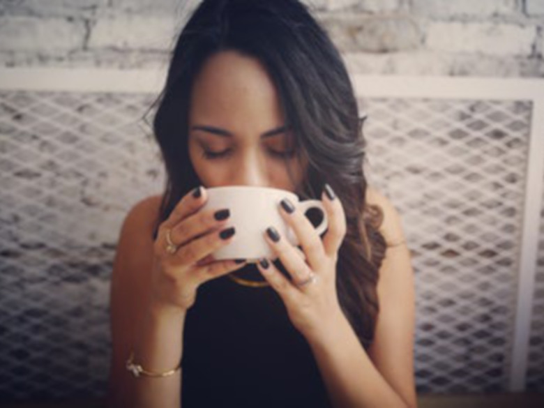 Woman peacefully drinking her coffee